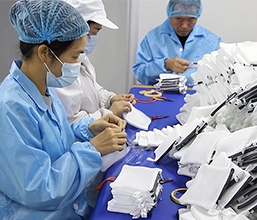 Workers inspect bag accessories and semi‑finished goods